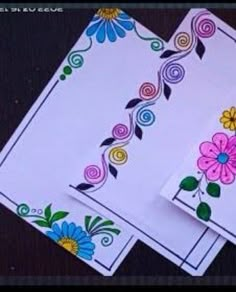 two white cards with colorful flowers on them