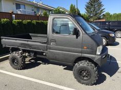 a gray truck parked in a parking lot