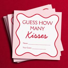 three cards with the words guess how many kisses are in front of them on a red background