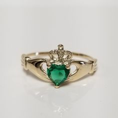 "Thanks for shopping our vintage estate store. We tend to sell well below wholesale and truly hope you enjoy all of our items. Many of the items are one of a kind, so please enjoy scrolling through the pictures and hopefully something will catch your eye. Black spots are from reflections. Beautiful estate 10k yellow gold created.25ct emerald Irish Claddagh ring. Ring size: 7 Setting 3/8\" 9mm  Band width: 1.5mm Weight: 1.28 grams Beautiful ring, marked 10k." Emerald Claddagh Ring, Irish Heart, Gold Claddagh Ring, Irish Ring Claddagh, Irish Claddagh, Claddagh Ring, Claddagh Rings, Heart Hands, Crown Ring