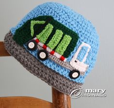 a crocheted hat with a truck on it sitting on top of a wooden chair