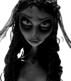 a creepy doll with big eyes and long hair wearing a headband on top of her head