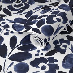 a blue and white wallpaper with black flowers on it