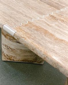 a wooden table with a metal handle on it