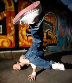 a person doing a handstand on the ground