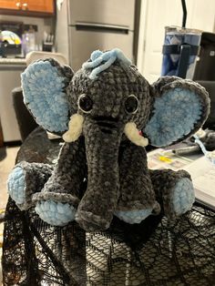 an elephant stuffed animal sitting on top of a net