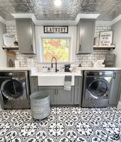 a washer and dryer sitting in a kitchen next to a window with the words laundry on it