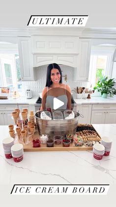 a woman standing in front of a kitchen counter with lots of food on top of it