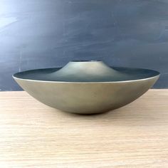 a bowl sitting on top of a wooden table