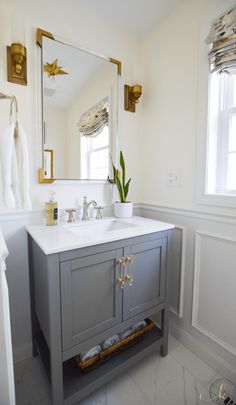 a bathroom with a sink, mirror and towel rack