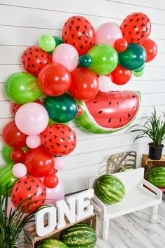 some watermelon balloons are hanging on the wall