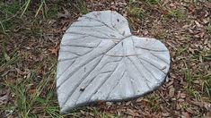 a heart shaped stone laying in the grass