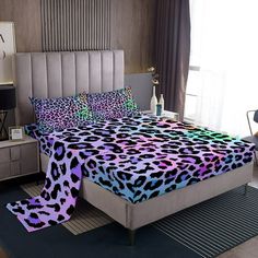 a bed with purple and black leopard print on it