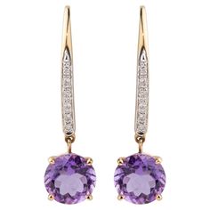 These earrings exude an undeniable beauty that captivates the eye. Crafted with meticulous attention to detail, each earring features vivid purple round brilliant-cut amethysts, totaling 3.28 carats, set on solid 14K yellow gold heavy basket-style dangles. Complementing their allure, 12 round brilliant-cut diamonds, with a total weight of 0.14 carats and of G-H color and SI clarity, adorn and pave-set these stunning earrings. With a total length of 1.25 inches, they command attention as a statement piece of exceptional elegance. Included with insurance and presented in a beautiful gift box, they offer both assurance and sophistication. Luxury Amethyst Teardrop Earrings, Luxury Rose Gold Amethyst Earrings, Luxury Gold Amethyst Earrings, Luxury Amethyst Gemstone Earrings, Luxury Pierced Amethyst Earrings, Basket Style, Diamond Dangle Earrings, Stunning Earrings, Beautiful Gift Boxes