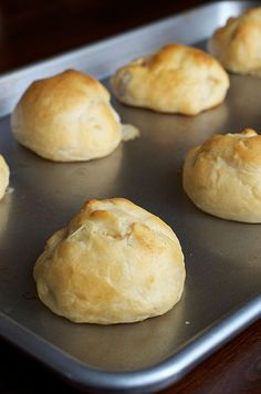 freshly baked pastries sitting in a metal pan