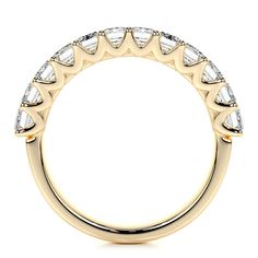 a yellow gold wedding band with pear shaped diamonds on the sides and side stones at the top