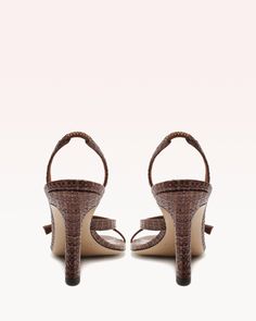 ***FINAL SALE*** The Tita Bell 85 in Brown by Alexandre Birman is a strappy, heeled sandal featuring a curved heel and raffia fabrication. Material: Spice Raffia Leather sole Round toe Heel height: 3.4in | 85mm SKU: B0604800020006 Ankle Heels, Alexandre Birman, Custom Label, Heeled Sandal, Round Toe Heels, Brown Sandals, Organic Beauty, Custom Labels, Final Sale