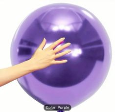 a woman's hand reaching for a large purple ball on a white background with the words color purple written below it