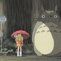 a person holding an umbrella standing in the rain with a totoro behind them