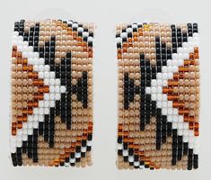 two pieces of beaded bracelets with black, white and orange designs on them