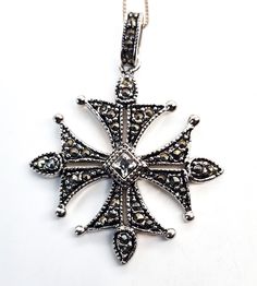 Maltese cross marcasite and rhinestone silver plated necklace. Good used condition with little to no signs of wear. No missing marcasite stones. Comes with sterling silver box chain. Necklace measures 19 inches long. Pendant measures 1 and 3/4ths of an inch tall and 1 and 1/4 of an inch wide. Antique Sterling Silver Cross Pendant Necklace, Vintage Silver Sterling Silver Cross Necklace, Vintage Sterling Silver Cross Necklace, Ornate Silver Cross Pendant Necklace, Antique Silver Cross Necklace Gift, Antique Silver Cross Necklace As Gift, Antique Silver Cross Necklace For Gift, Ornate Silver Cross Necklace, Antique Silver Cross Pendant Necklace