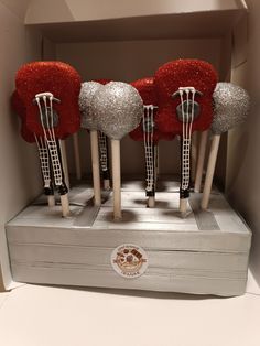 five red and silver hair pins in a box