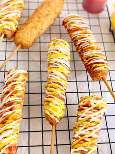 several skewers filled with different types of food sitting on top of a table