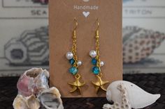 These beachy dangle earrings are handmade and hand assembled with beachy vibes in mind!  The material is delicate and should not be worn in water or with oils and lotions! Handmade Blue Summer Jewelry, Handmade Summer Blue Jewelry, Beachy Gold Dangle Earrings, Handmade Coastal Jewelry For Summer, Handmade Beachy Jewelry For Beach Season, Bohemian Summer Jewelry In Ocean Color, Summer Bohemian Blue Jewelry, Summer Bohemian Ocean Color Jewelry, Summer Bohemian Style Blue Jewelry