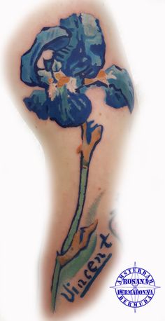 a blue flower tattoo on the back of a woman's arm with words underneath it