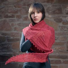 a woman wearing a red knitted shawl