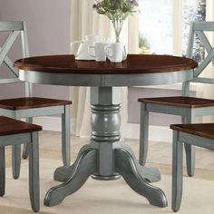 a dining room table with two chairs around it