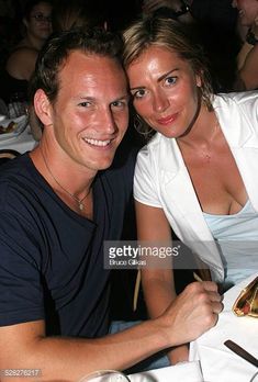 a man and woman sitting at a table together