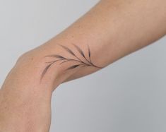 a person's arm with a small tattoo on it