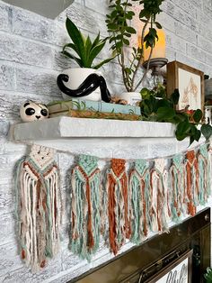 there is a fireplace with some plants on the mantle