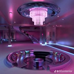 a large circular room with stairs and chandelier in the center is lit by purple lighting