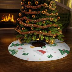 a christmas tree with gold ornaments on it in front of a fire placemat and fireplace