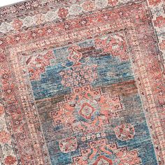 an antique persian rug with blue, red and orange colors on the middle part of it