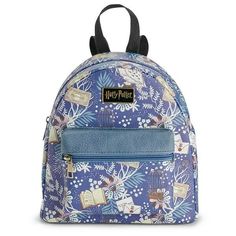 a harry potter backpack with flowers and books on the front, it has a zippered pocket