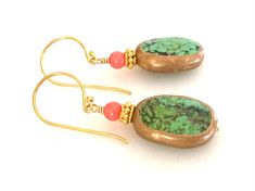 "Beautiful genuine green turquoise gemstones edged in golden copper with pale orange coral accent on 24k gold vermeil ear hooks. Artisan lime green turquoise gemstones are natural 17 x 12 x 6mm oval stones edged in golden copper. Each side has unique matrix patterns giving it a lovely rustic appearance. 4mm natural coral rounds in pale orange add pop of color. Accented with 24k gold vermeil spacer beads. Lightweight earrings hang from 24k gold vermeil artisan ear wires. Total length is 1 1/2\"." Gold Chrysoprase Earrings For Gift, Gold Chrysoprase Earrings As A Gift, Handmade Turquoise Chrysoprase Earrings, Handmade Turquoise Jade Earrings, Coral Accents, Golden Copper, Turquoise And Coral, Pale Orange, Aquamarine Earrings