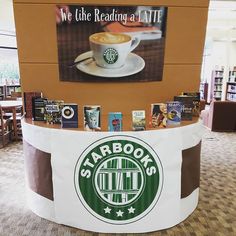 a starbucks coffee stand with books on it