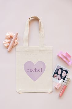 a personalized tote bag with the word rachel on it next to some hair clips