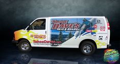 a white van is parked in front of a black background and has an advertisement on the side