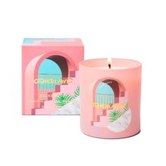 a pink candle sitting next to a box