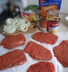 some food is laying out on a white paper towel and next to it are cans of campbell's soup