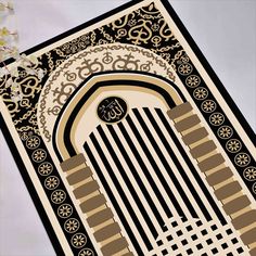 an intricately designed area rug is displayed on a table with flowers in the background