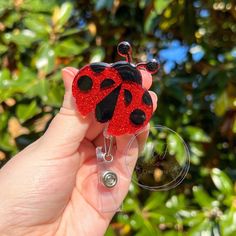 "Ladybug Glitter Interchangeable Badge Reel This Ladybug Glitter Badge Reel is a perfect for any Healthcare worker, or anyone who uses a badge, but uses a plain old boring badge reel! The Ladybug Badge Reel is interchangeable so you can switch them out for another cute charm any time you want. This adorable Ladybug has a red glitter backing to add some sparkle to anyones work attire! The Ladybug Badge Reel is a great gift for a medical worker or even a graduation gift for a future medical professional. The Ladybug Badge Reel would also be a great gift for anyone who needs to wear a badge like teachers, healthcare worker, even students! It adds a cute touch to any scrub top, work shirt or blouse, shirt pocket, and more!  Ladybug Badge Charm can be attached to two different Reel options. A C Cute Lanyards, Black Lanyard, The Ladybug, Star Badge, Badge Lanyard, Cute Charms, Loose Outfit, Clear Vinyl, Red Glitter