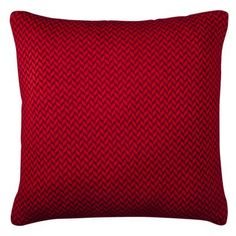 a red pillow with a diamond pattern on the front and back, sitting on a white background