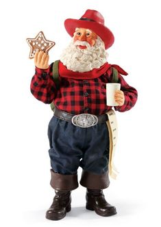 a santa clause figurine holding a star and pointing to it's right