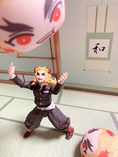 an action figure is posed in front of a ball and another character appears to be playing with it