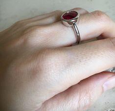 "A Classic oval shaped Faceted Lab Created Ruby Sterling Silver Ring featuring a comfort fit band with a bezel around the stone. This makes a great birthstone ring for those July Birthdays! Wrapped in a box ready for gift giving.(r-537) RING INFO ---------------- STERLING SILVER Stone with Bezel measure 11.5mm x 10mm July BIRTHSTONE *Follow us @belesasjewelry on Instagram for promotions/giveaways *LIKE* us on Facebook http://www.facebook.com/Belesas *If you like the ring, please click on the \"P Star Labs, Red Rings, Faceted Ring, Bezel Ring, Red Gemstones, July Birthstone, Rings Simple, Ruby Ring, Birthstone Ring